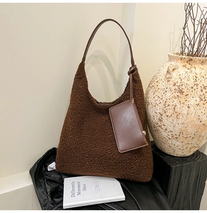 Close-up of deep brown teddy fur hobo bag with a matching leather pouch accessory
