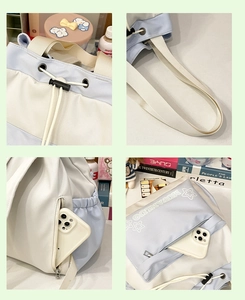 Detail view of the drawstring closure, wide straps, and pockets of the canvas backpack