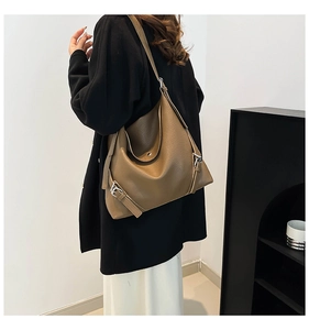 Detail of coffee brown pebbled leather hobo bag with silver metallic buckle accents