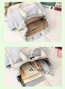 Detail showing spacious interior with zipper pocket in blue and white canvas tote bag