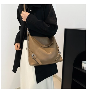 Detail of brown lychee texture and silver metal buckle on large tote shoulder bag