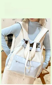 Detail view of water-resistant nylon tote backpack in blue and beige color blocking