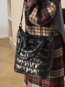 Glossy black quilted puffer tote bag with adjustable shoulder strap for autumn winter style