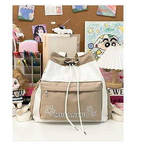 Detail of canvas drawstring bucket backpack with contrast stitching and star embroidery
