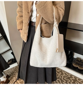 Détail du sac fourre-tout en peluche crème avec anse en cuir et petite pochette zippée