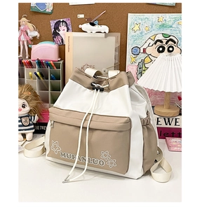 Close-up of color-block drawstring backpack with embroidered star and side pocket detail