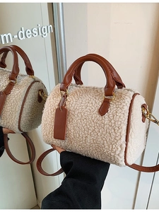 Beige faux shearling Boston pillow bag with brown leather trim and adjustable strap