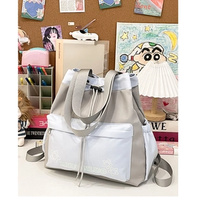 Detail of multi-functional tote bag with contrast stitching and star motif front pocket