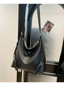 Minimalist black pebble leather tote bag with silver adjustable buckles and hobo design