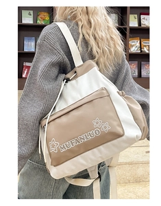 Detail of canvas tote bag with drawstring closure and star print on a model's back