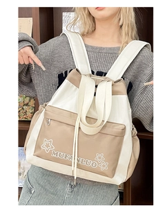 Detail of a large white and beige tote backpack with star pattern in a library setting