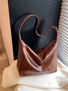 Minimalist brown PU leather half-moon shoulder bag with retro pleated design for women