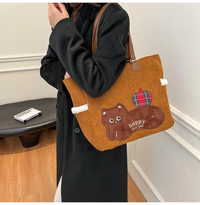 Detail of caramel corduroy tote with cat patch embroidery and sheepskin trim