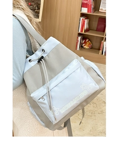 Detail of light blue and grey nylon drawstring backpack with star print and zipper pocket