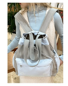 Close-up of dual-tone tote backpack featuring blue and beige nylon with star print detail