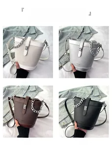 Detail view of retro bucket bags with litchi grain texture and metal chain in four colors