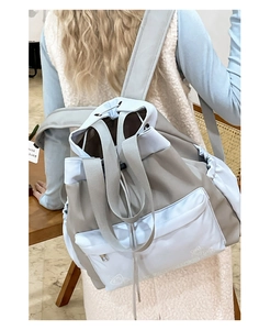 Detail view of water-resistant nylon backpack with star pattern and drawstring closure
