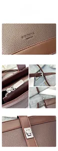 Detail showing high-quality lychee pattern leather and silver hardware on brown bucket bag