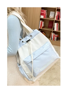 Detailed back view of a light blue and white drawstring tote bag with star pattern and zip