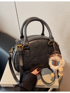Retro black shell crossbody bag with litchi grain texture and a cute bear pendant decoration