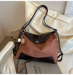 Detail of vintage matte patchwork tote bag with silver twist lock and baseball charm
