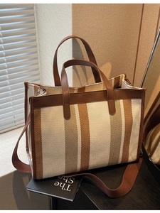 Large capacity striped canvas tote bag with brown leather trim and crossbody strap