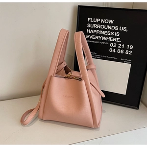 Close-up of pink bucket bag with HAMROO brand logo and litchi grain leather detail