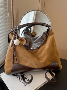 Brown leather large tote bag with metallic ring handles and mirror reflection detail