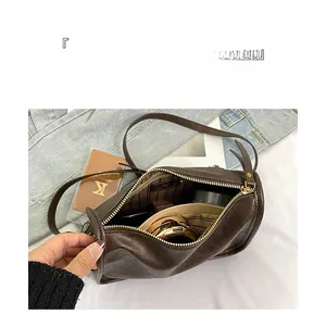 Détails de l'intérieur du sac cylindrique marron montrant les compartiments utiles