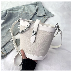 Detail of lychee pattern leather bucket bag with silver chain and FOUDIYA logo