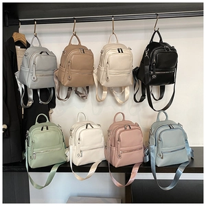 Matrix display of eight colorful casual backpacks with premium lychee grain texture