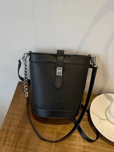 Retro black leather bucket bag with silver twist lock and crossbody chain strap