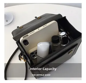 Interior view showing the large storage capacity of the black leather crossbody bag