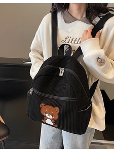 Black corduroy backpack for women featuring cute bear embroidery and decorative zipper