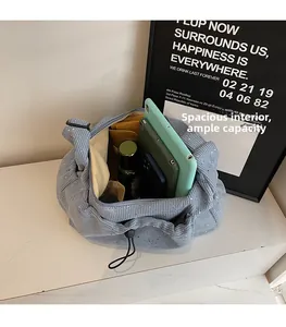 Spacious interior of corduroy tote bag showing capacity for phone and cosmetics