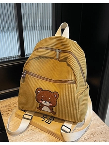 Yellow corduroy backpack featuring a cute cartoon bear embroidery and top handles