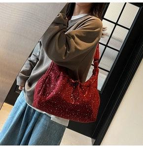 Detail of red corduroy tote bag with star pattern and adjustable shoulder strap