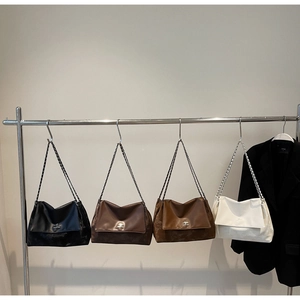 Detail of four vintage chain shoulder bags in black, coffee, brown, and cream white colors