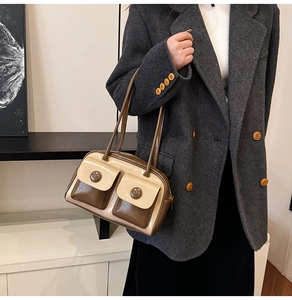 Close-up of beige and brown retro shoulder bag featuring vintage buttons and pocket details