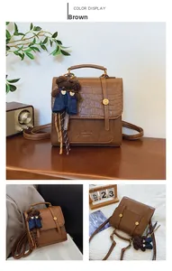 Brown crossbody bag with crocodile texture flap and cute bear pendant detail