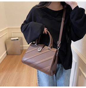 Dettaglio borsa a mano marrone in pelle PU a grana con eleganti finiture in metallo argento