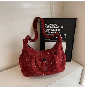 Detail of burgundy corduroy crescent tote bag with splash pattern and drawstring pocket