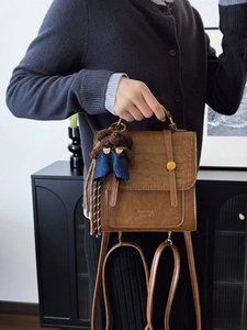 Brown crocodile texture leather backpack with metal handle and cute bear charm