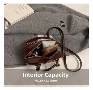 Detail of burgundy crossbody bag interior showing spacious room for phone and cosmetics