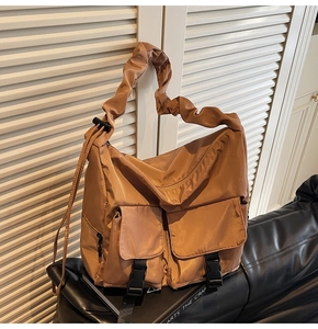 Close-up of caramel nylon tote bag featuring cargo pockets and stylish ruffled shoulder strap