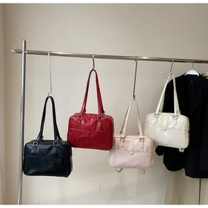 Showcase of glossy shoulder bags in black, red, light pink, and milky white colors