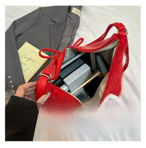 Spacious interior of red faux fur tote bag with leather strap and zipper closure