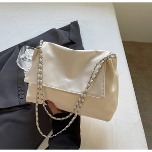 Detail of cream leather shoulder bag with silver chain strap and MICHTAM logo on flap
