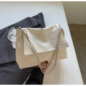 Close-up of cream leather tote with silver chain strap and MICHTAM logo on the front
