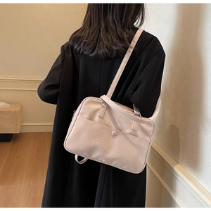 Close-up of pink PU leather crossbody bag with Noronoro logo and adjustable shoulder strap